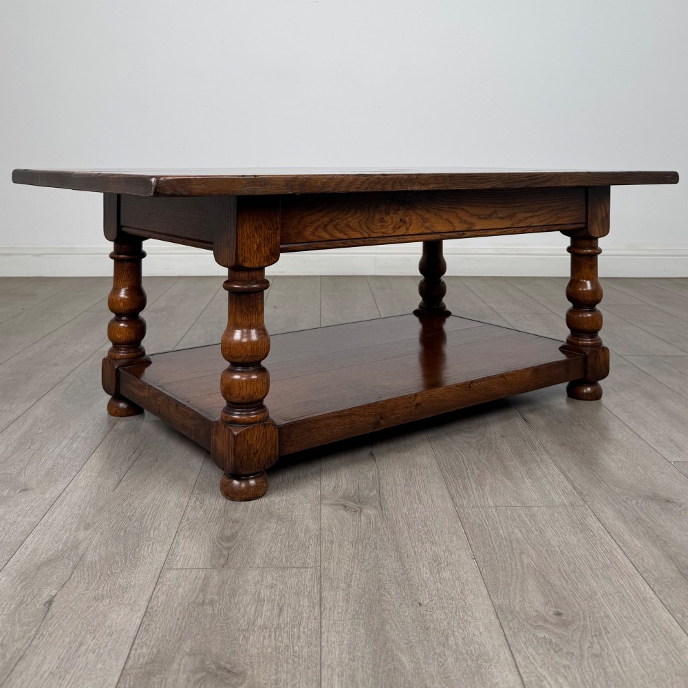 A rectangular dark oak coffee table featuring turned baluster legs and a full-length lower shelf. View VIII