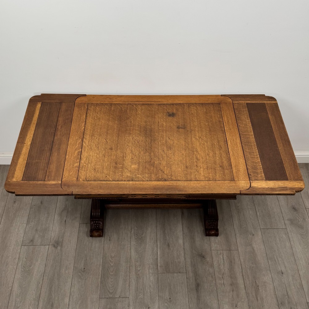 An antique Edwardian oak draw-leaf dining table featuring carved bulbous supports and a central stretcher. View V