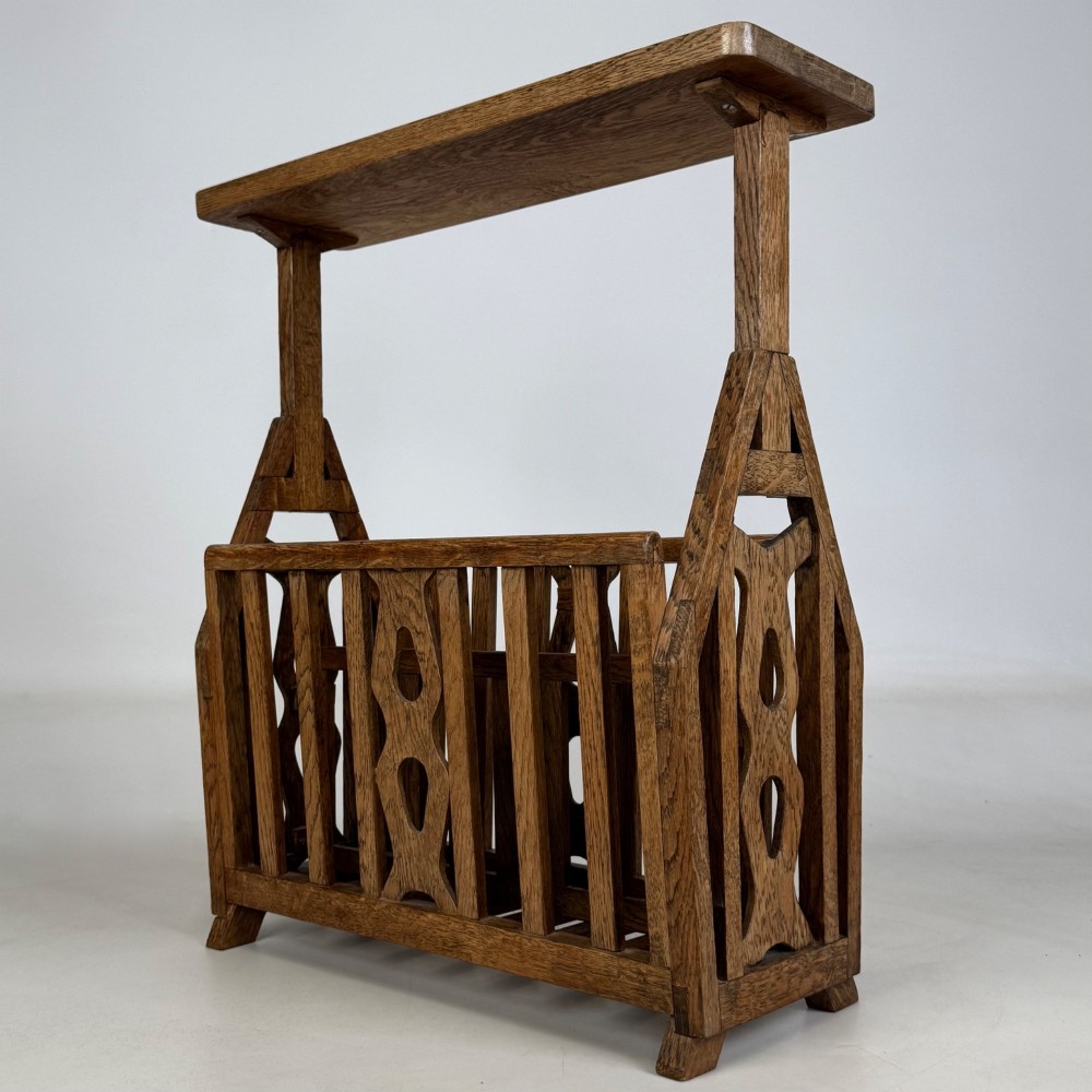 An antique Arts and Crafts oak side table featuring a rectangular top supported by slender uprights above a slatted lower magazine trough. View VI