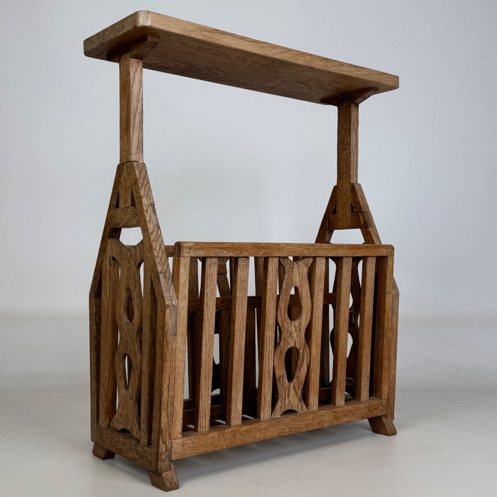 An antique Arts and Crafts oak side table featuring a rectangular top supported by slender uprights above a slatted lower magazine trough. View VIII
