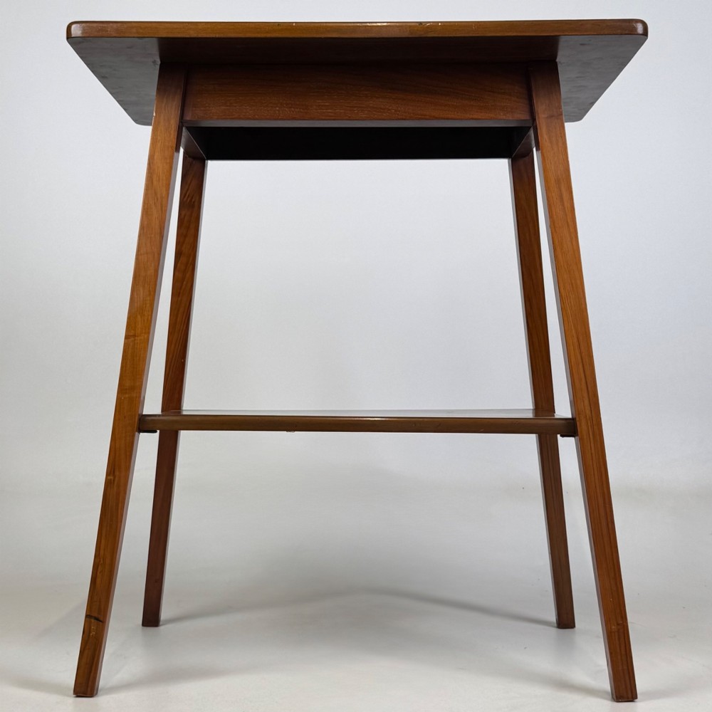 An Edwardian walnut side table featuring square apron framing, four splayed tapered legs, and an integrated lower undertier shelf.