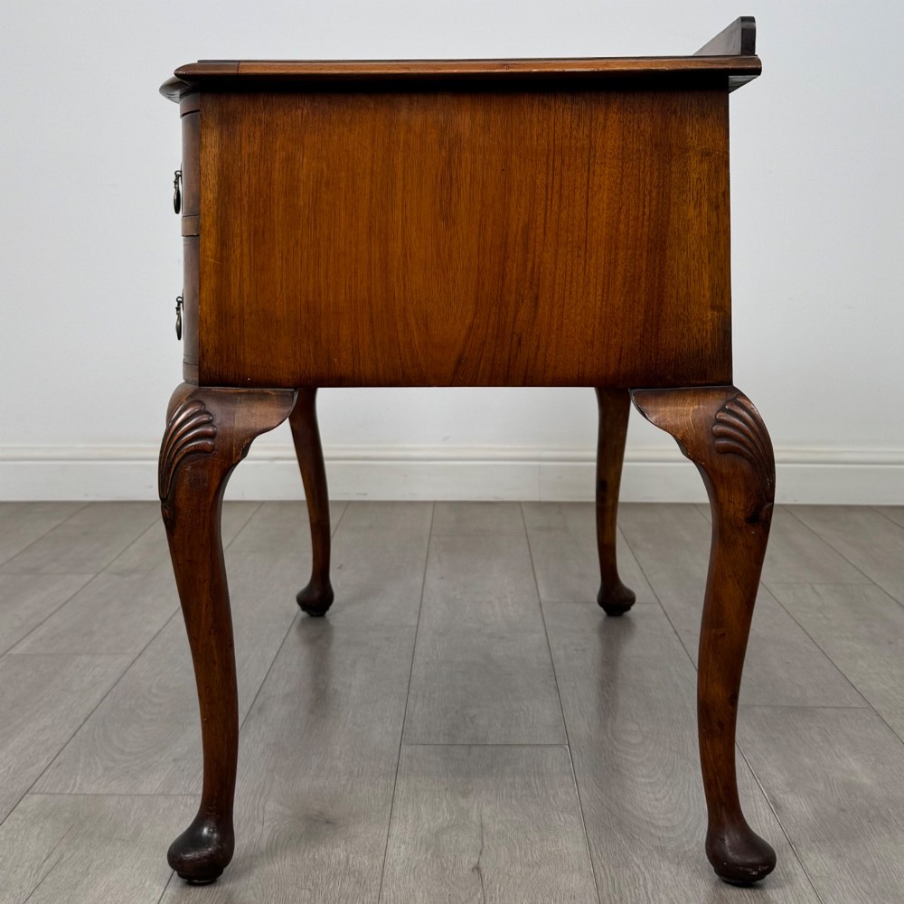 An Edwardian burr walnut writing table featuring five drawers with brass drop handles and carved cabriole legs. View III