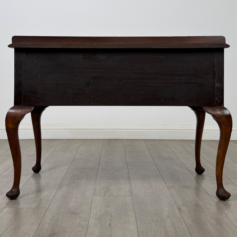 An Edwardian burr walnut writing table featuring five drawers with brass drop handles and carved cabriole legs. View V
