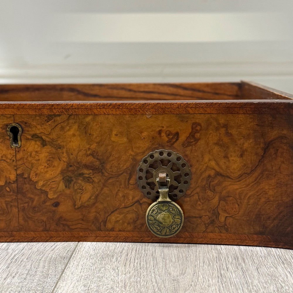 An Edwardian burr walnut writing table featuring five drawers with brass drop handles and carved cabriole legs. View XI
