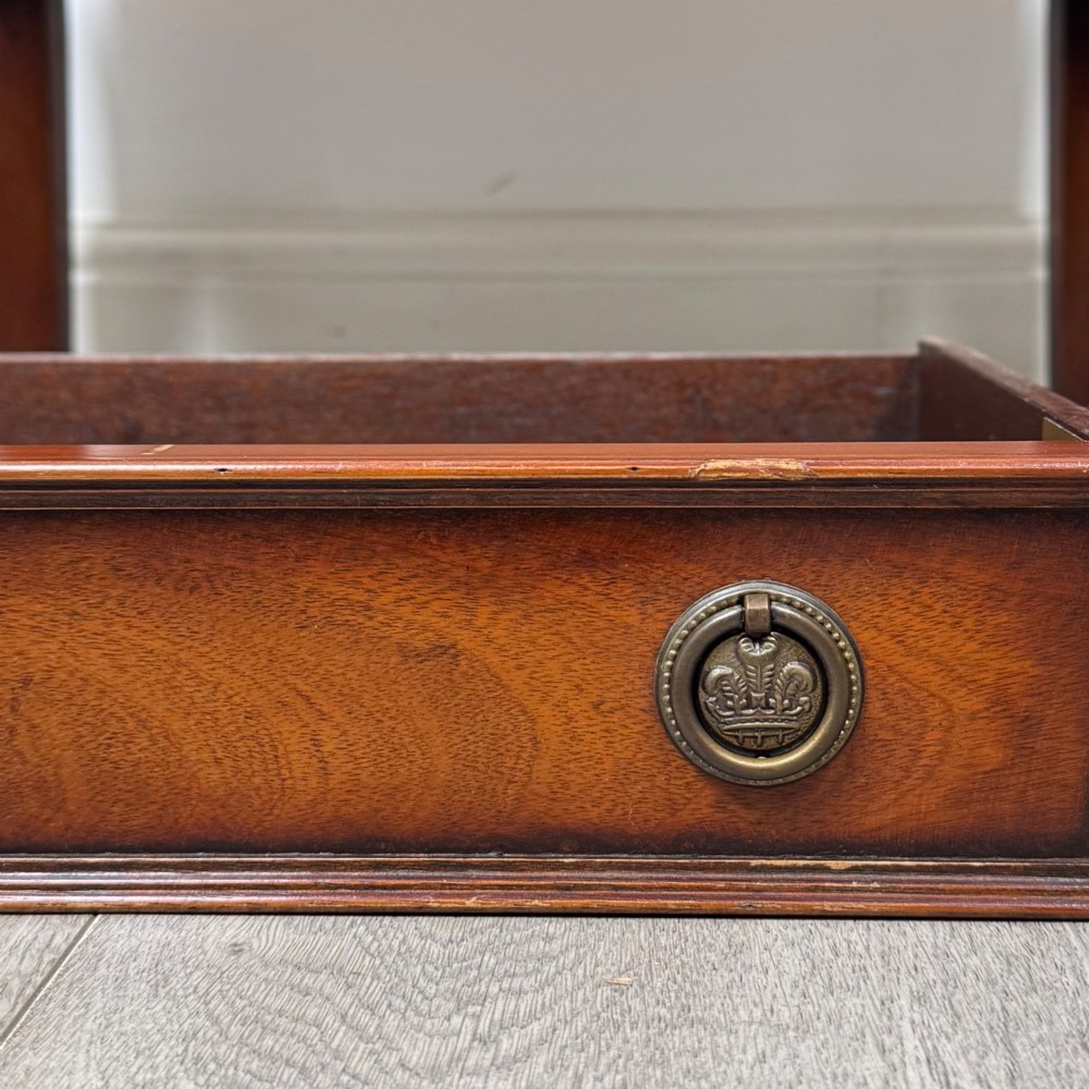 A small mahogany bedside cabinet with a top drawer, brass ring pull handles, an open lower shelf, and straight tapered legs. View XI