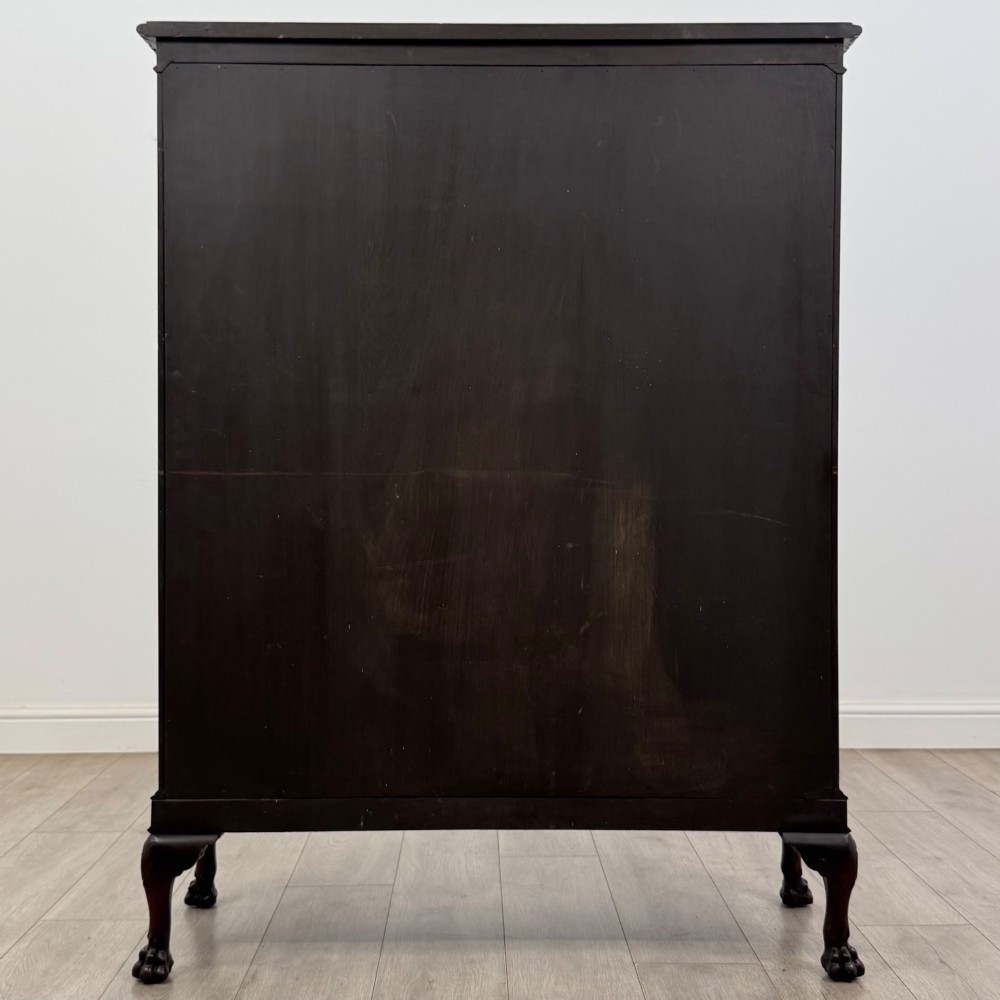 An Edwardian dark mahogany display cabinet featuring double astragal glazed doors and cabriole legs with carved claw and ball feet. View VI