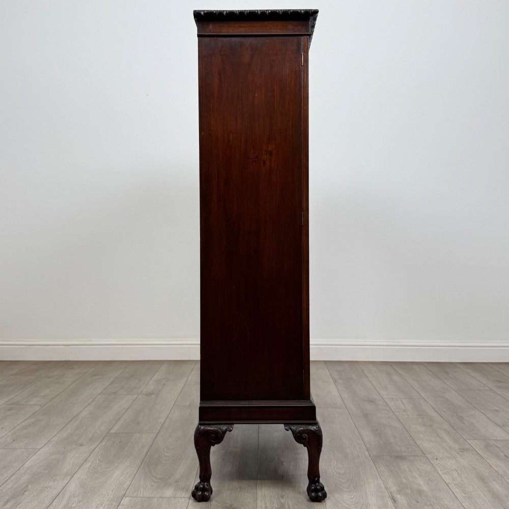 An Edwardian dark mahogany display cabinet featuring double astragal glazed doors and cabriole legs with carved claw and ball feet. View VIII