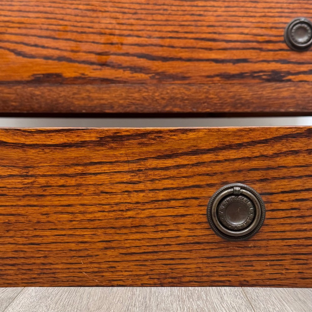 An Edwardian oak chest of drawers featuring three full-width drawers with circular pull handles, supported by straight square legs. View XI