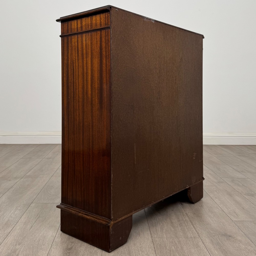 An Edwardian dark mahogany low open bookcase with three shelves and a moulded top. View V