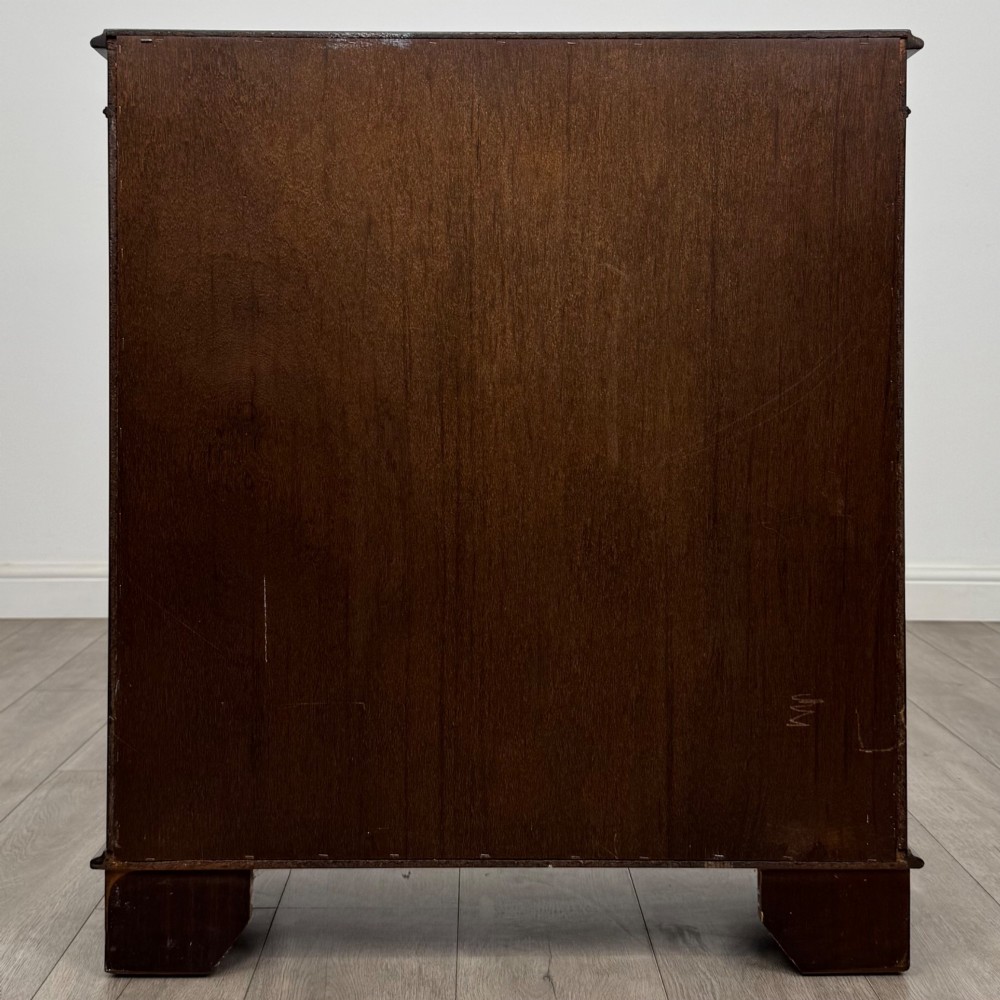 An Edwardian dark mahogany low open bookcase with three shelves and a moulded top. View VI