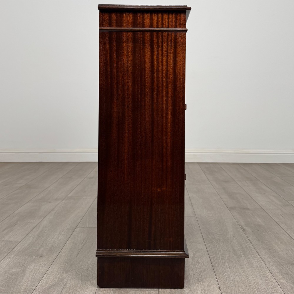 An Edwardian dark mahogany low open bookcase with three shelves and a moulded top. View VIII