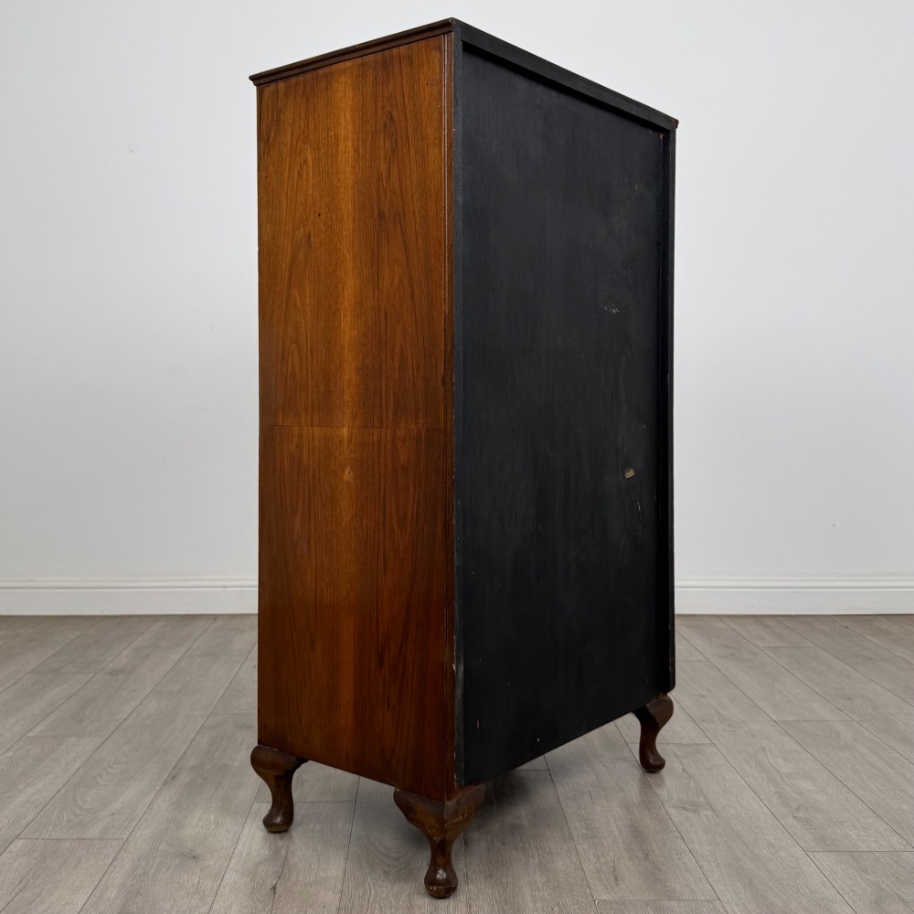 An Edwardian burr walnut storage cupboard featuring two top doors with brass strap hinges above two drawers on cabriole legs. View V