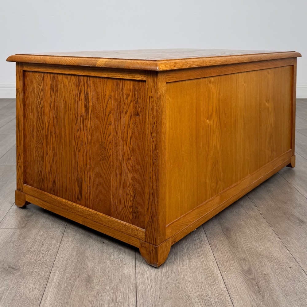 A low 20th-century oak chest of drawers featuring five drawers arranged across three tiers with diamond-shaped metal handles. View IV