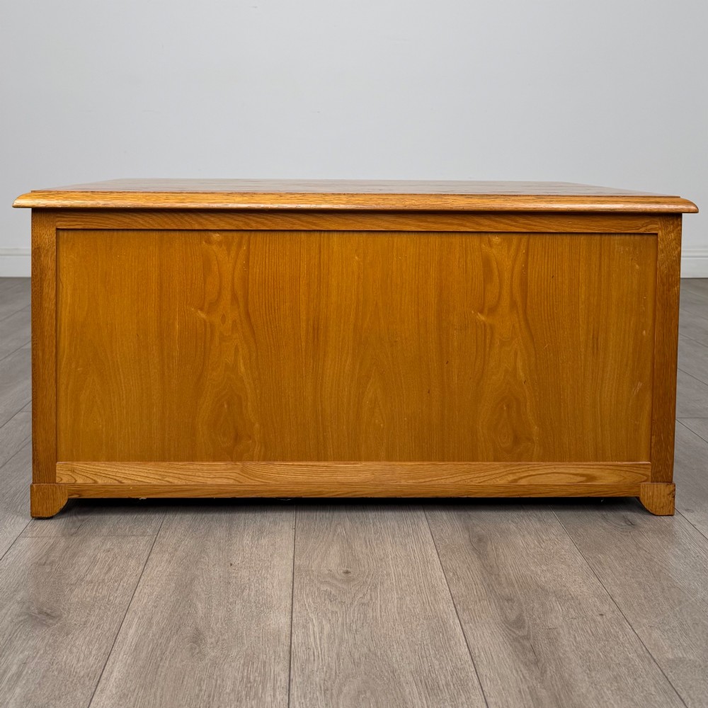 A low 20th-century oak chest of drawers featuring five drawers arranged across three tiers with diamond-shaped metal handles. View V