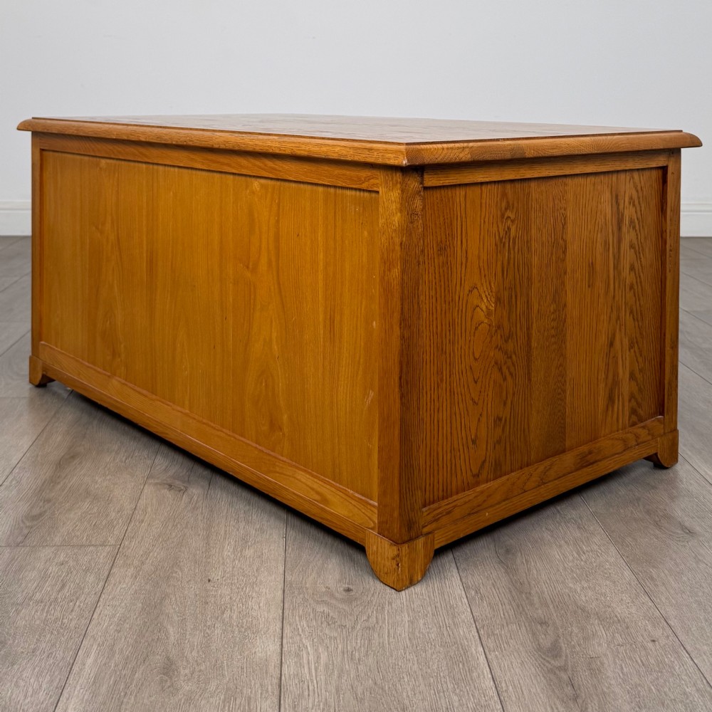 A low 20th-century oak chest of drawers featuring five drawers arranged across three tiers with diamond-shaped metal handles. View VI