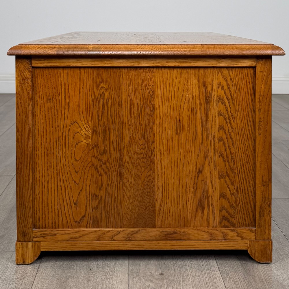 A low 20th-century oak chest of drawers featuring five drawers arranged across three tiers with diamond-shaped metal handles. View VII