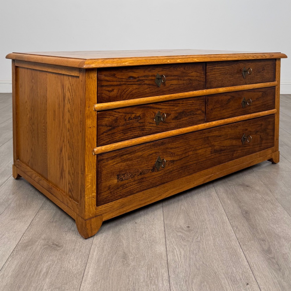 A low 20th-century oak chest of drawers featuring five drawers arranged across three tiers with diamond-shaped metal handles. View VIII