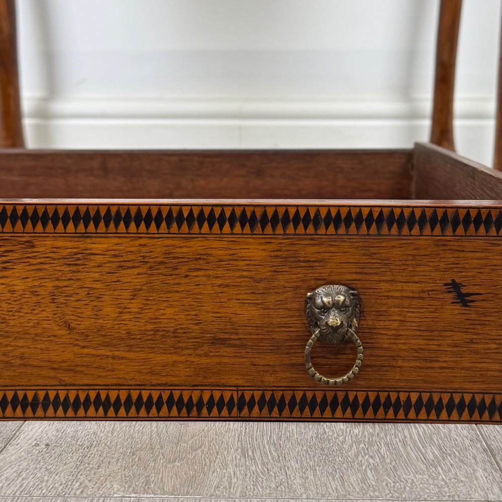 An 18th-century Georgian oak side table featuring a single drawer with geometric inlaid border, lion mask brass ring handles, shaped apron, and four cabriole legs ending in pad feet. View XI