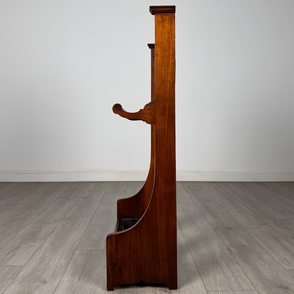 An Edwardian walnut hall stand featuring a fluted central column, metal coat hooks, a horizontal umbrella rail, and a metal drip tray at the base. View III