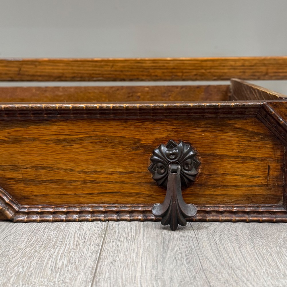 An Edwardian golden oak sideboard featuring a raised mirror back gallery, two drawers, two cabinet doors with geometric mouldings, and barley twist front legs. View XII