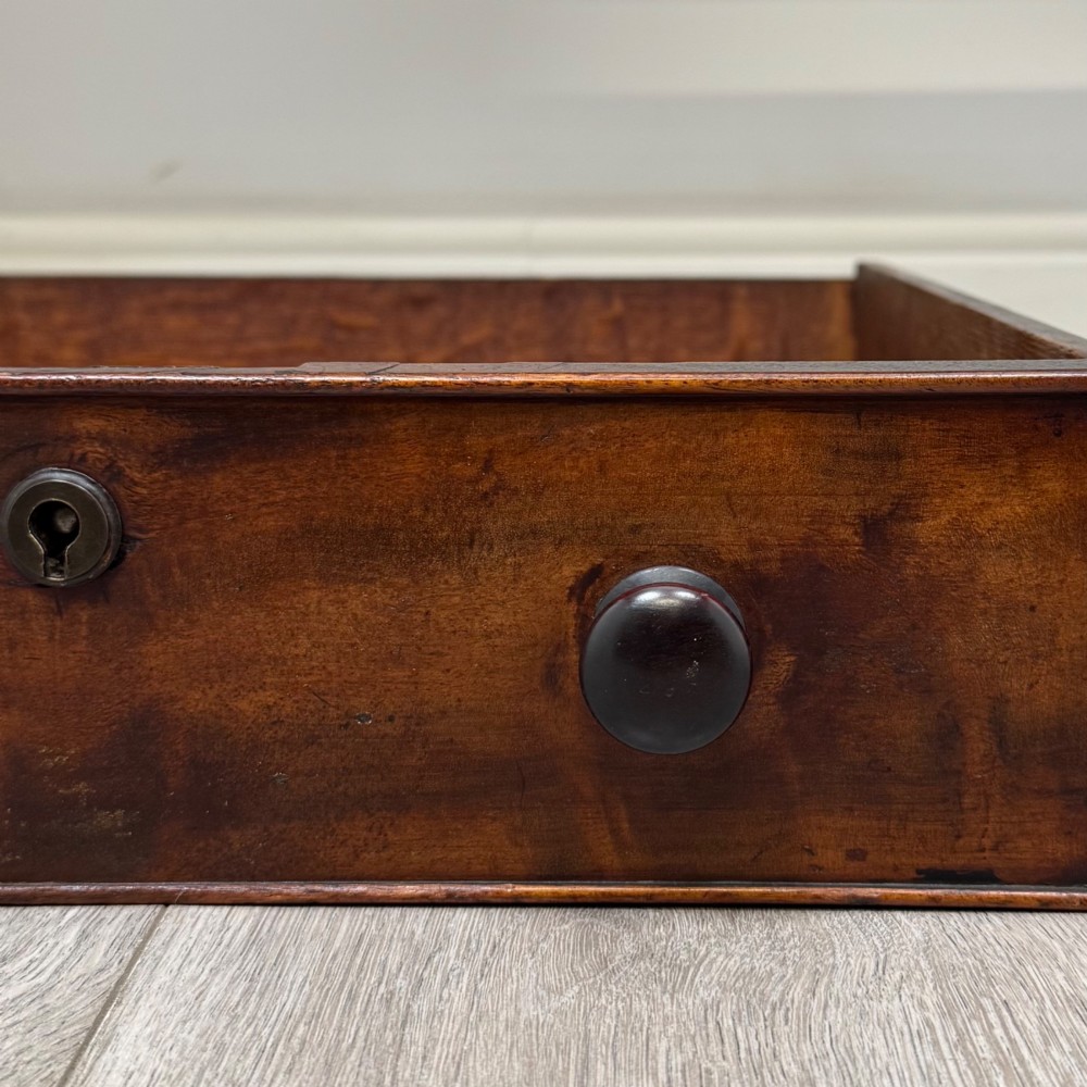 A Victorian dark mahogany writing table with two drawers, turned wooden knob handles, keyhole escutcheons, and four turned legs. View XI