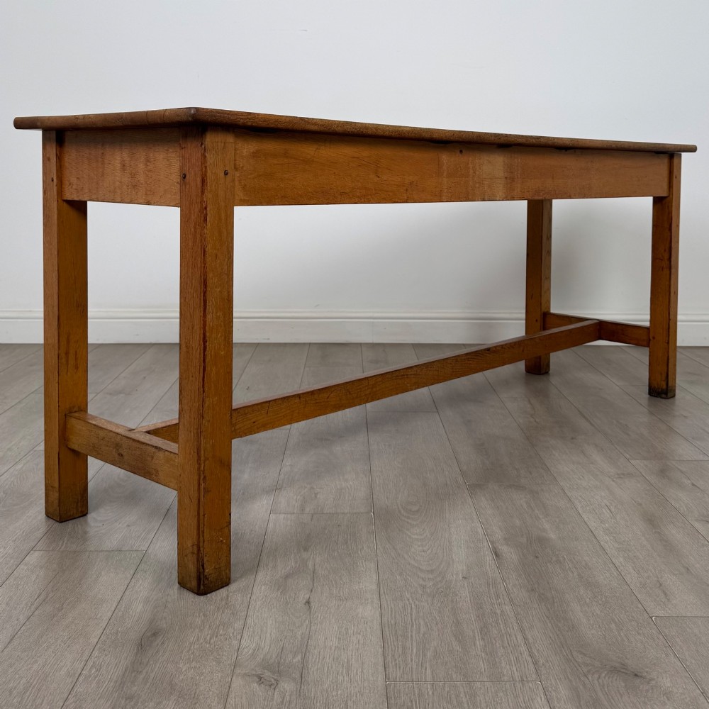 A long 20th century oak side table featuring a plain rectangular top, four square legs, and a low central stretcher. View IV