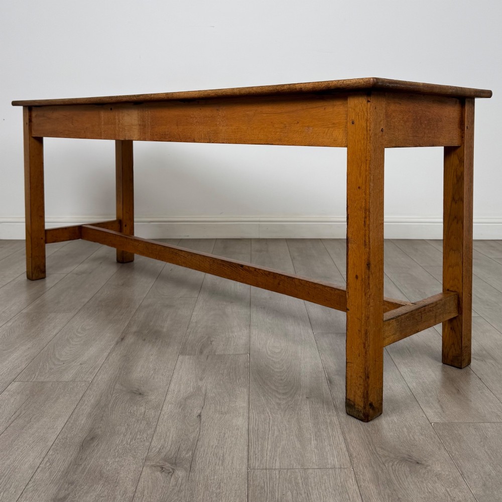 A long 20th century oak side table featuring a plain rectangular top, four square legs, and a low central stretcher. View VI
