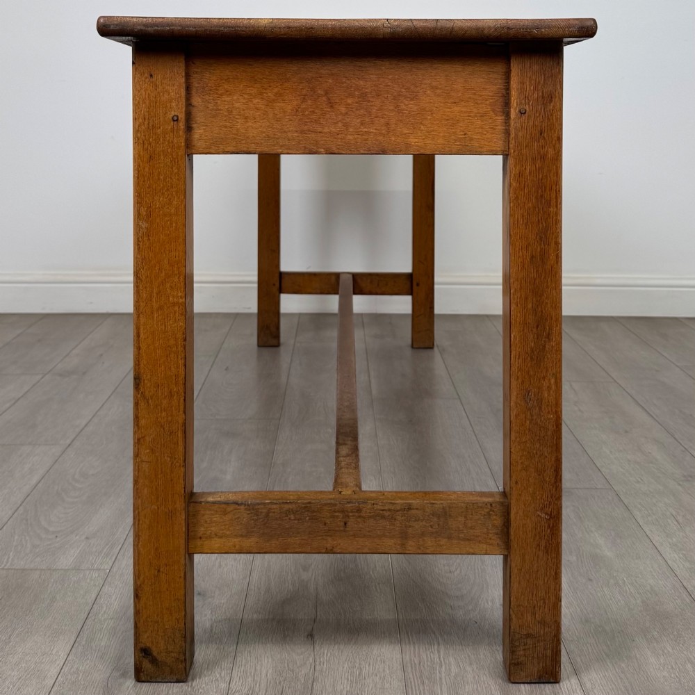 A long 20th century oak side table featuring a plain rectangular top, four square legs, and a low central stretcher. View VII