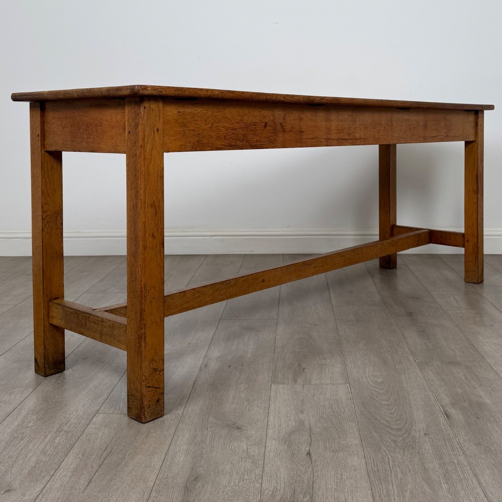 A long 20th century oak side table featuring a plain rectangular top, four square legs, and a low central stretcher. View VIII