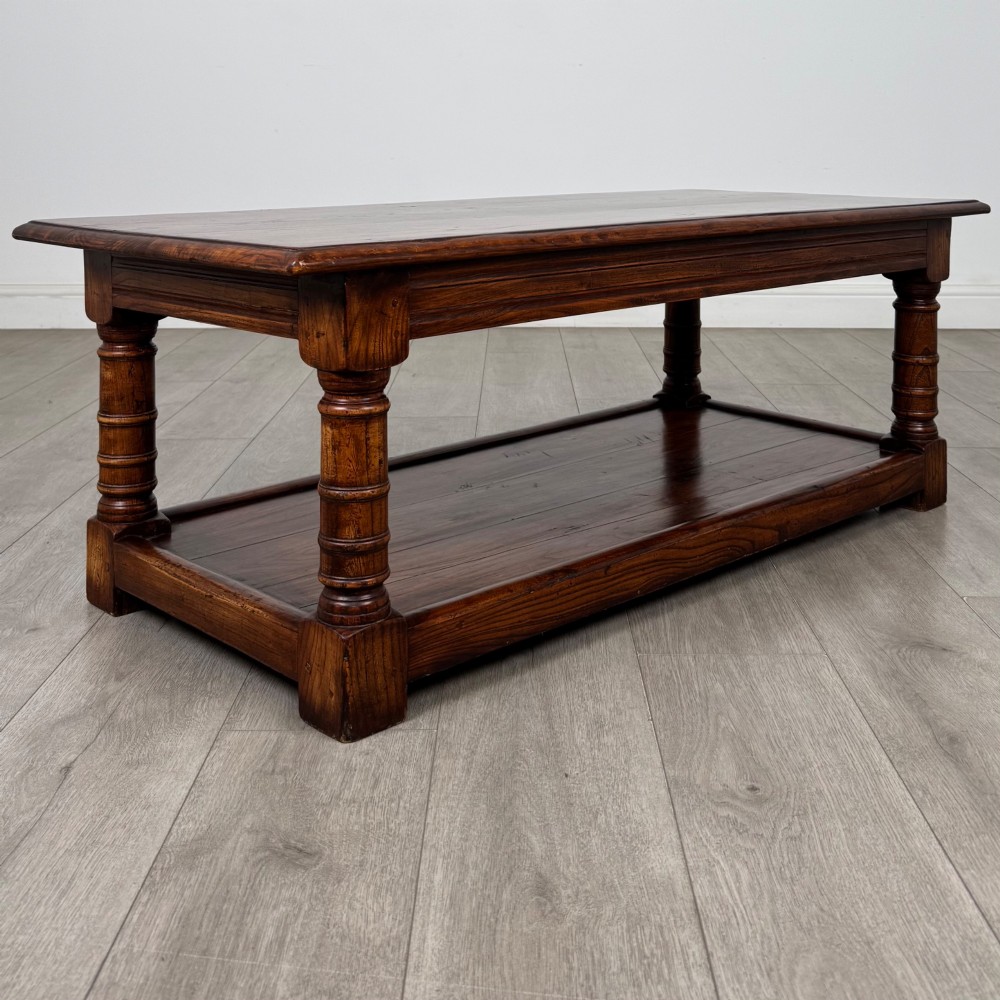 A low rectangular dark oak coffee table featuring turned legs and a solid lower shelf. View IV