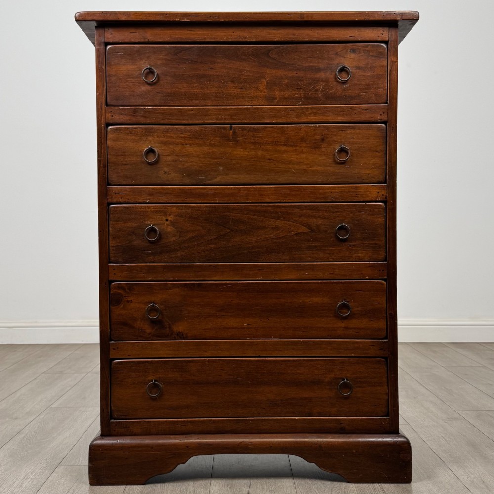 A tall dark brown hardwood chest of drawers featuring five horizontal drawers fitted with metal ring pull handles.
