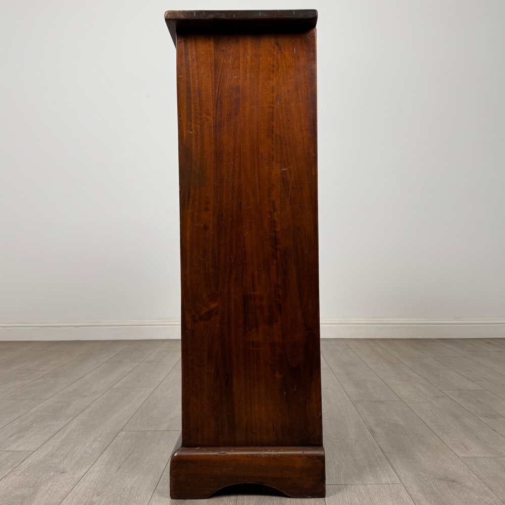 A tall dark brown hardwood chest of drawers featuring five horizontal drawers fitted with metal ring pull handles. View III