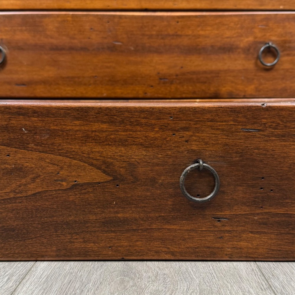 A tall dark brown hardwood chest of drawers featuring five horizontal drawers fitted with metal ring pull handles. View XI