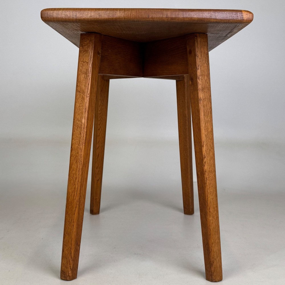 A rectangular golden oak coffee table with tapered splayed legs and visible wooden peg joinery. View III