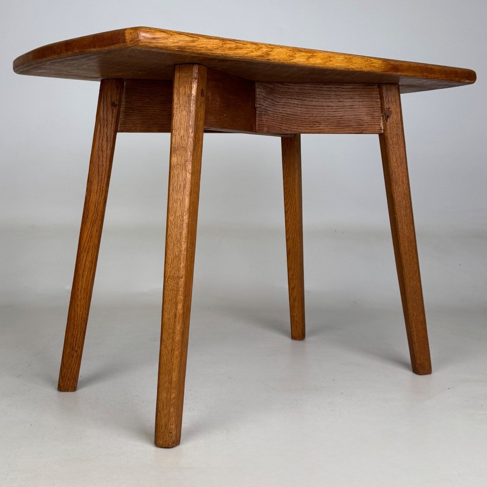 A rectangular golden oak coffee table with tapered splayed legs and visible wooden peg joinery. View IV