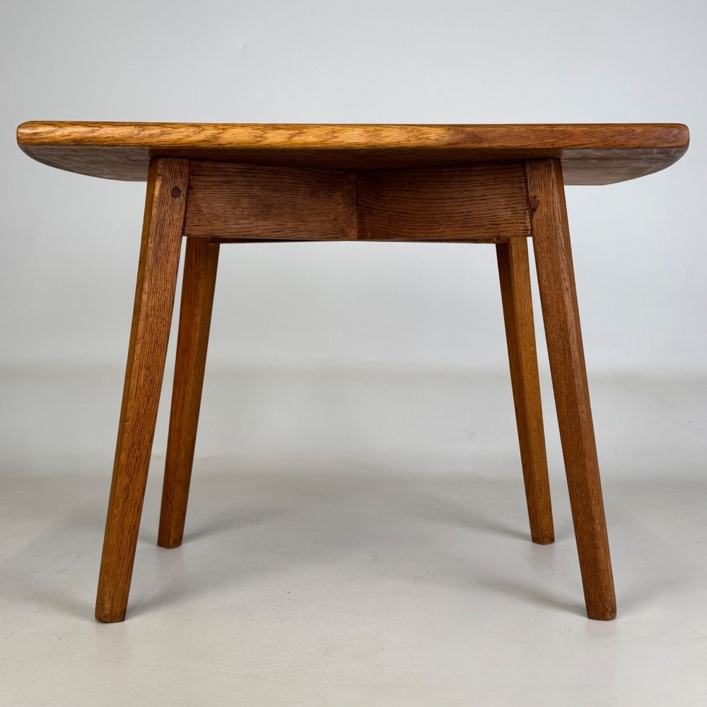 A rectangular golden oak coffee table with tapered splayed legs and visible wooden peg joinery. View V
