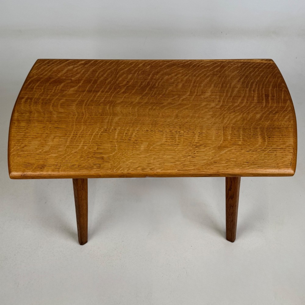 A rectangular golden oak coffee table with tapered splayed legs and visible wooden peg joinery. View IX