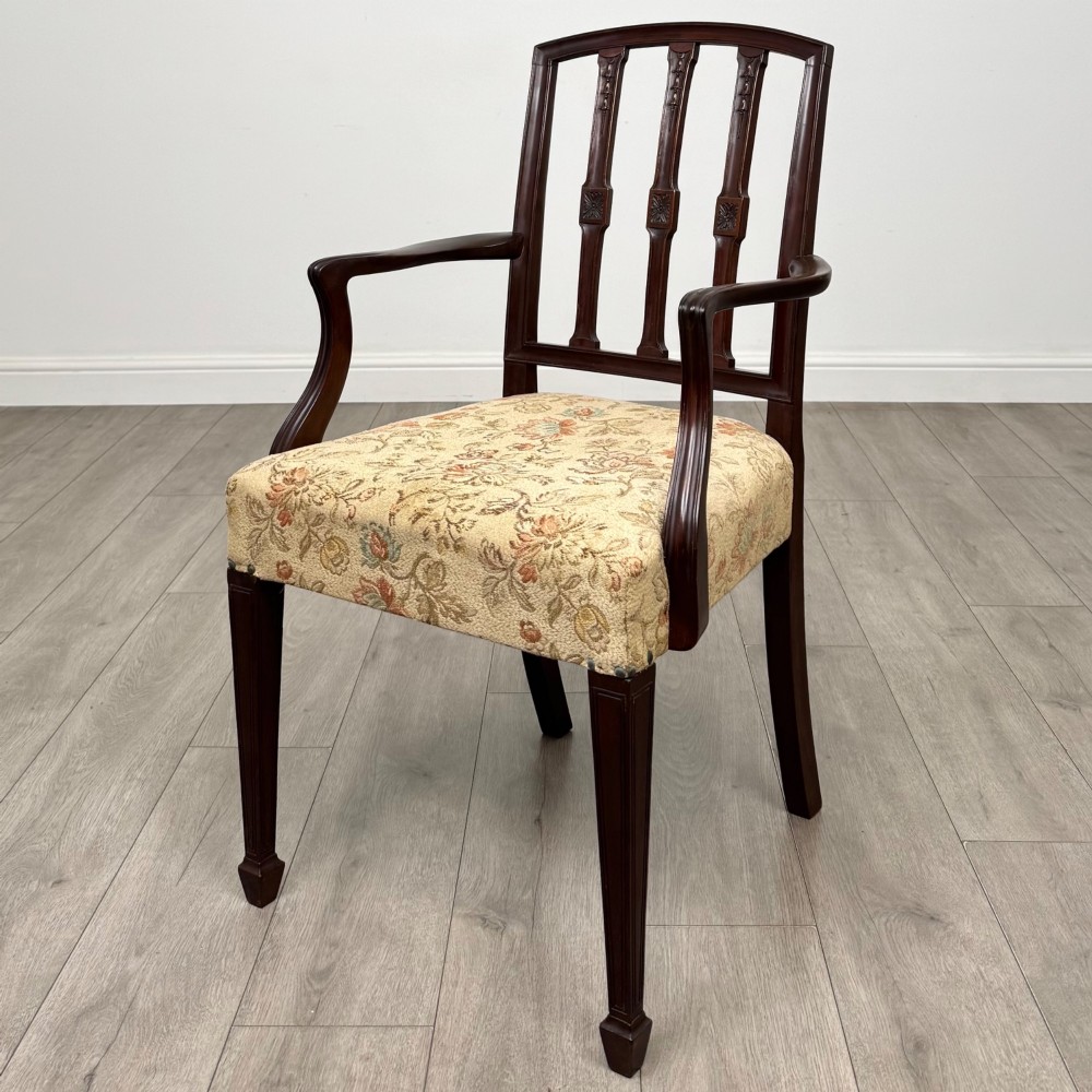 A set of six dark mahogany dining chairs featuring carved vertical back splats, square tapered legs, and floral upholstered seats. View II