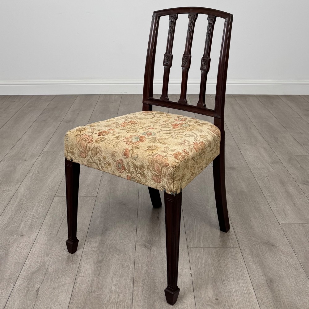 A set of six dark mahogany dining chairs featuring carved vertical back splats, square tapered legs, and floral upholstered seats. View IV