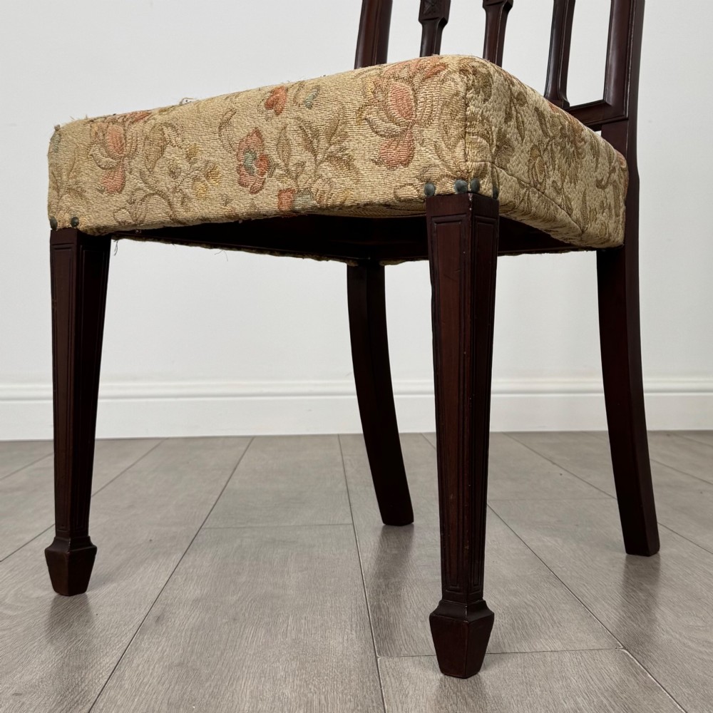 A set of six dark mahogany dining chairs featuring carved vertical back splats, square tapered legs, and floral upholstered seats. View VII