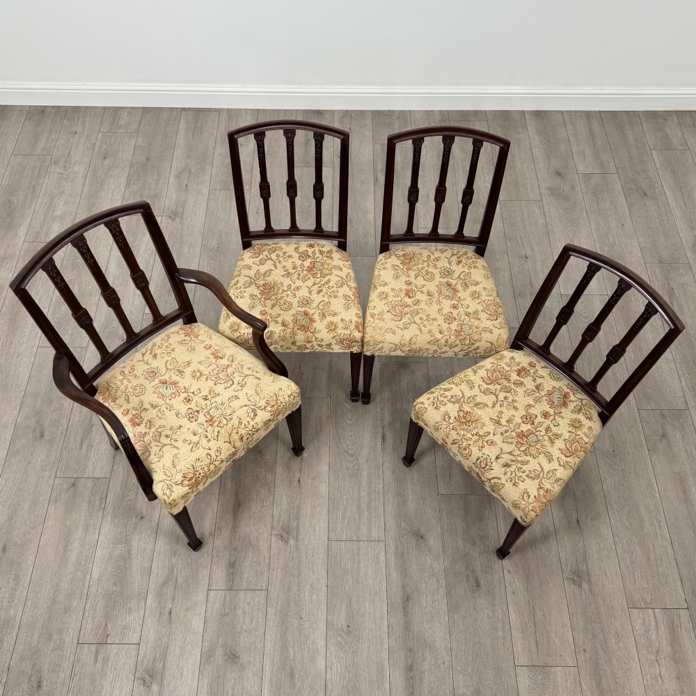 A set of six dark mahogany dining chairs featuring carved vertical back splats, square tapered legs, and floral upholstered seats. View IX