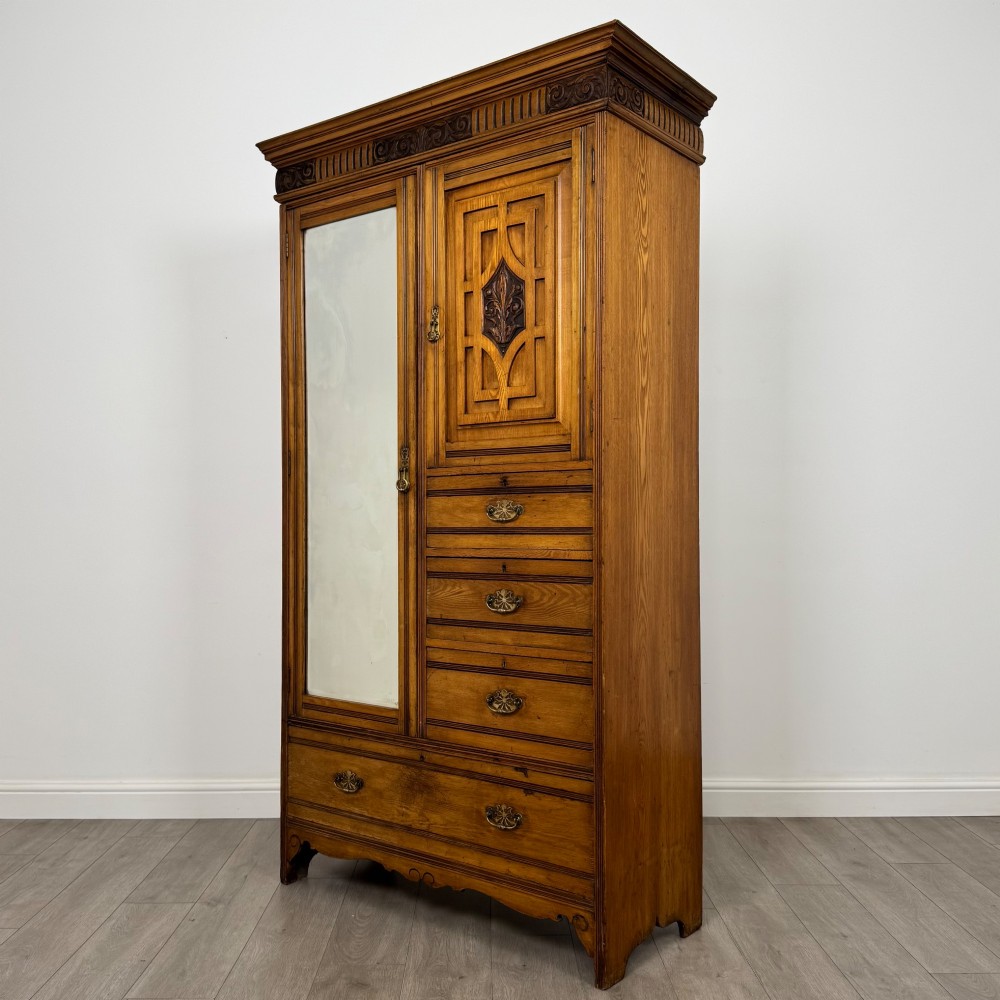 A 19th-century ash compactum wardrobe featuring a full-length mirrored door on the left and a carved cupboard with four drawers on the right above a long base drawer. View III