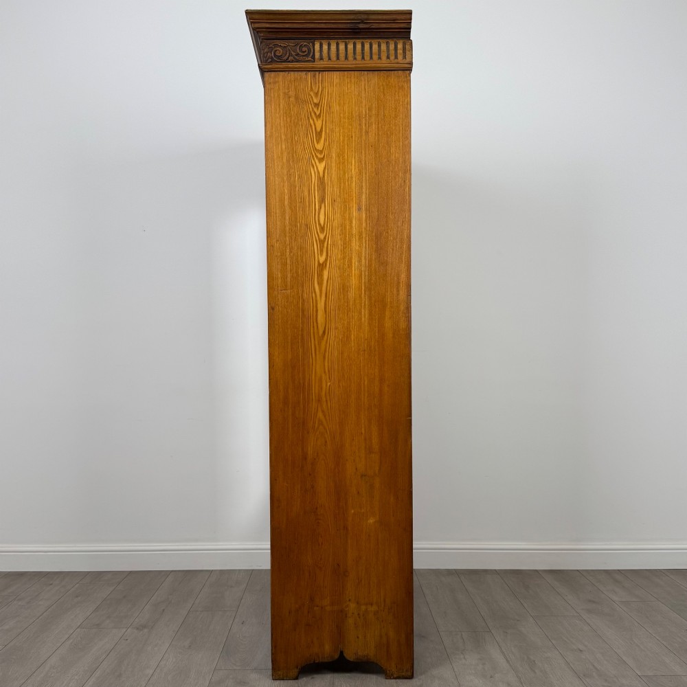 A 19th-century ash compactum wardrobe featuring a full-length mirrored door on the left and a carved cupboard with four drawers on the right above a long base drawer. View IV