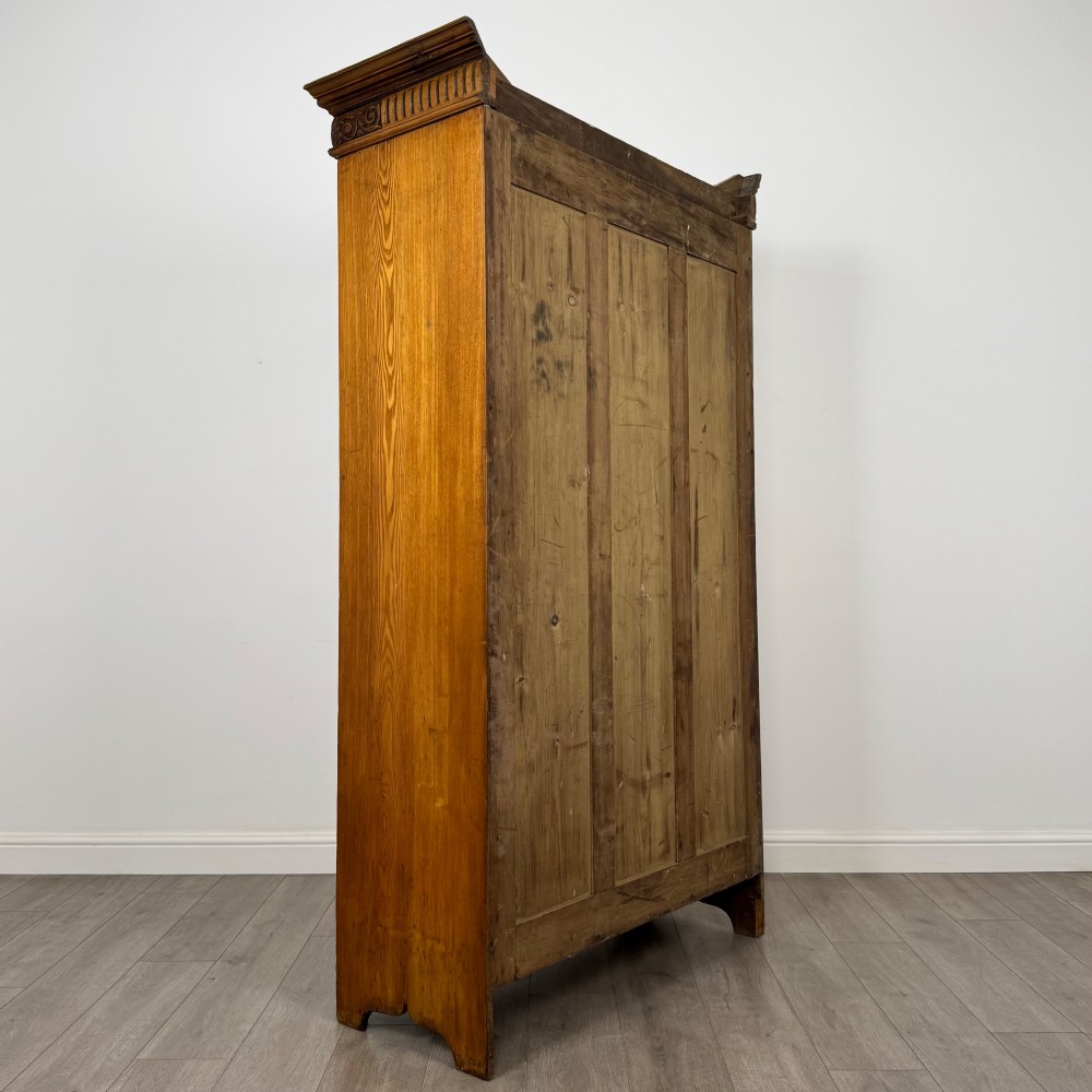 A 19th-century ash compactum wardrobe featuring a full-length mirrored door on the left and a carved cupboard with four drawers on the right above a long base drawer. View V
