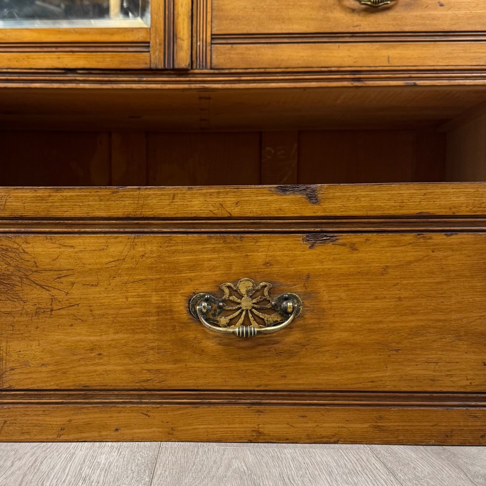 A 19th-century ash compactum wardrobe featuring a full-length mirrored door on the left and a carved cupboard with four drawers on the right above a long base drawer. View XI