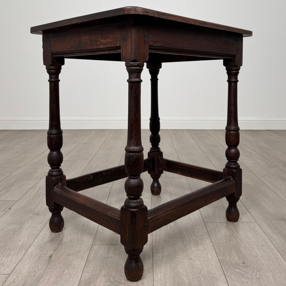 An antique dark oak side table featuring a rectangular flat top, four turned legs, and a lower four-sided stretcher base. View IV