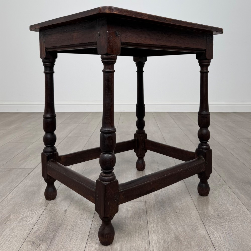 An antique dark oak side table featuring a rectangular flat top, four turned legs, and a lower four-sided stretcher base. View VIII