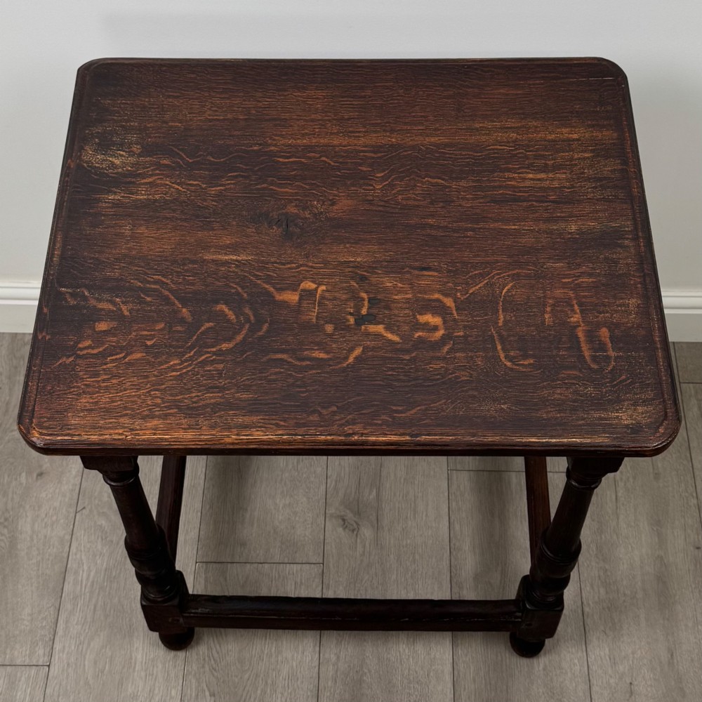 An antique dark oak side table featuring a rectangular flat top, four turned legs, and a lower four-sided stretcher base. View IX