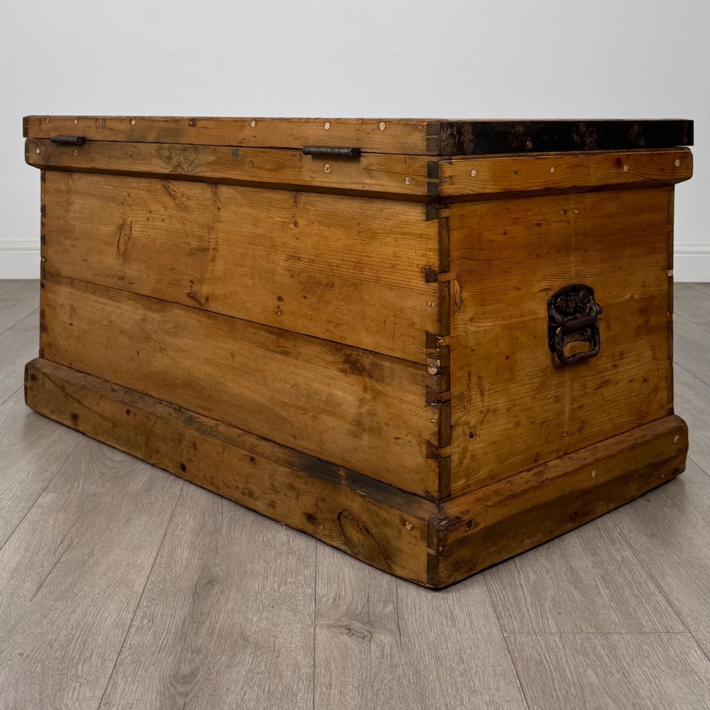A nineteenth-century pine storage chest featuring visible hand-cut dovetail corner joints and a moulded base. View VI