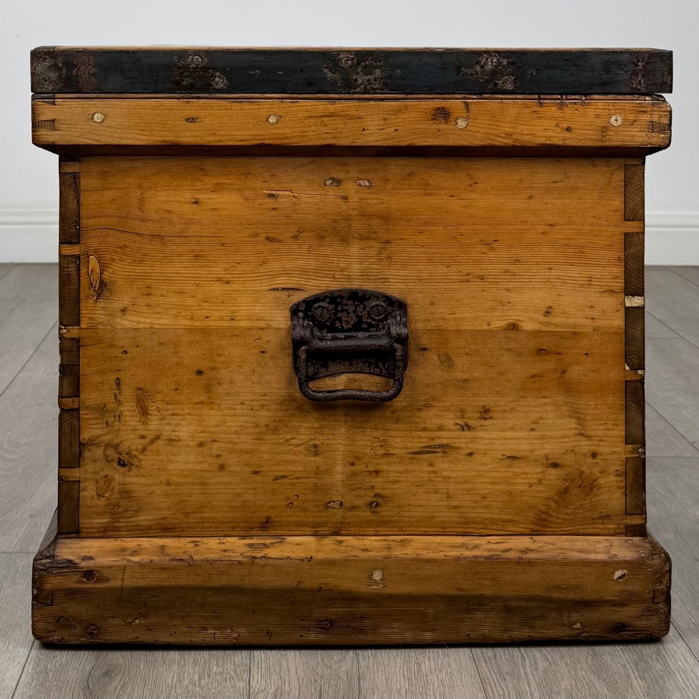 A nineteenth-century pine storage chest featuring visible hand-cut dovetail corner joints and a moulded base. View VII